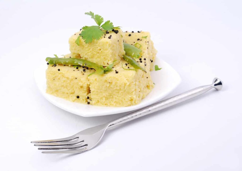 Dhokla on a plate with a fork - Probiotic Indian Food 5